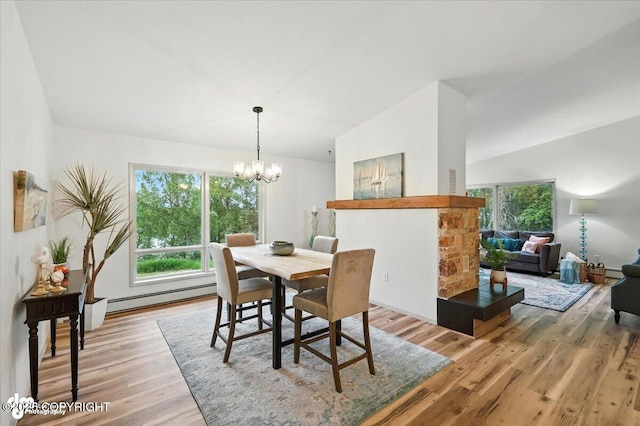 3291 N Edgewater Dr, Wasilla, AK 99623 - dining room with a baseboard heating unit, light wood-style floors, and a chandelier