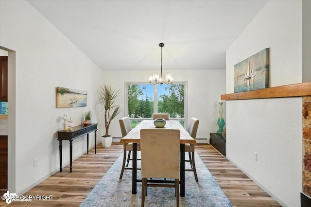 3291 N Edgewater Dr, Wasilla, AK 99623 - dining area featuring a baseboard radiator, a chandelier, light wood finished floors, and lofted ceiling