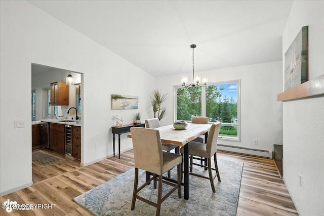 3291 N Edgewater Dr, Wasilla, AK 99623 - dining area featuring a baseboard heating unit, vaulted ceiling, light wood-type flooring, a chandelier, and wine cooler