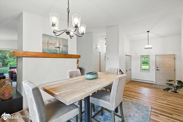 3291 N Edgewater Dr, Wasilla, AK 99623 - dining room featuring a baseboard radiator, a chandelier, and wood finished floors
