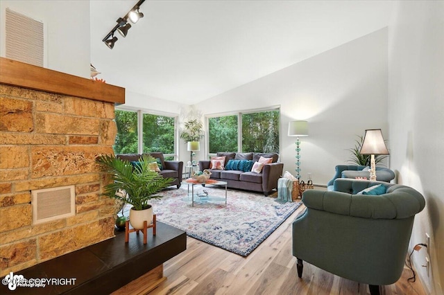 3291 N Edgewater Dr, Wasilla, AK 99623 - living area with wood finished floors, vaulted ceiling, and track lighting