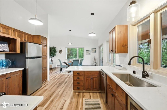 3291 N Edgewater Dr, Wasilla, AK 99623 - kitchen with stainless steel appliances, light wood finished floors, light countertops, brown cabinetry, and high vaulted ceiling