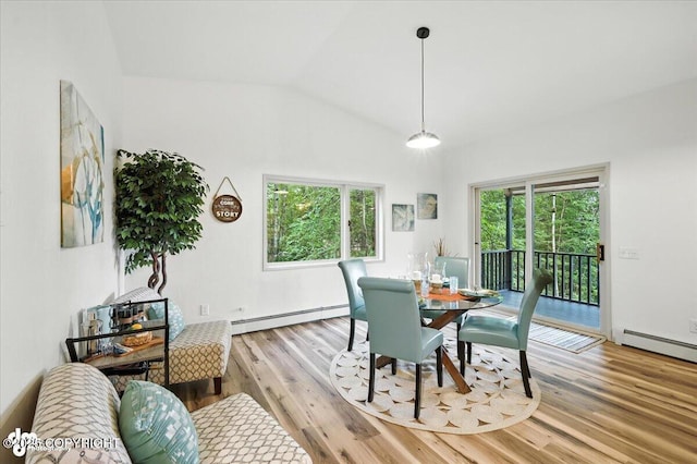 3291 N Edgewater Dr, Wasilla, AK 99623 - dining area with vaulted ceiling, a baseboard radiator, and light wood finished floors