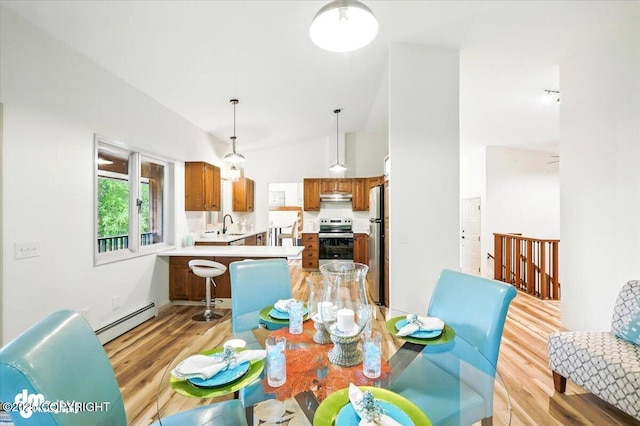 3291 N Edgewater Dr, Wasilla, AK 99623 - dining area with a baseboard radiator, light wood-style floors, and vaulted ceiling