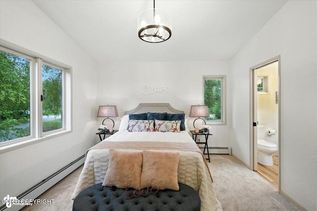 3291 N Edgewater Dr, Wasilla, AK 99623 - bedroom with a baseboard radiator, carpet floors, a chandelier, ensuite bath, and vaulted ceiling