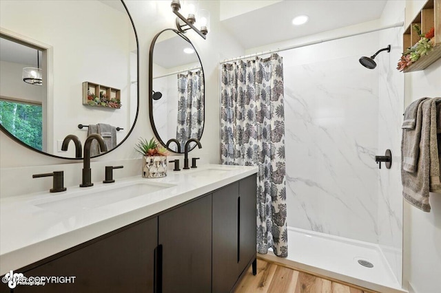 3291 N Edgewater Dr, Wasilla, AK 99623 - bathroom featuring double vanity, a marble finish shower, and wood finished floors