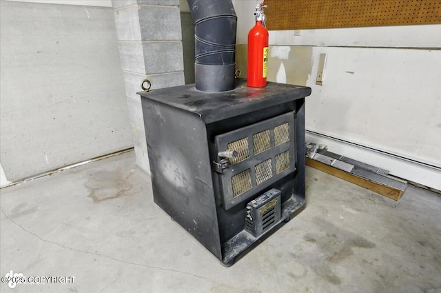 3291 N Edgewater Dr, Wasilla, AK 99623 - detailed view of a wood stove and unfinished concrete floors