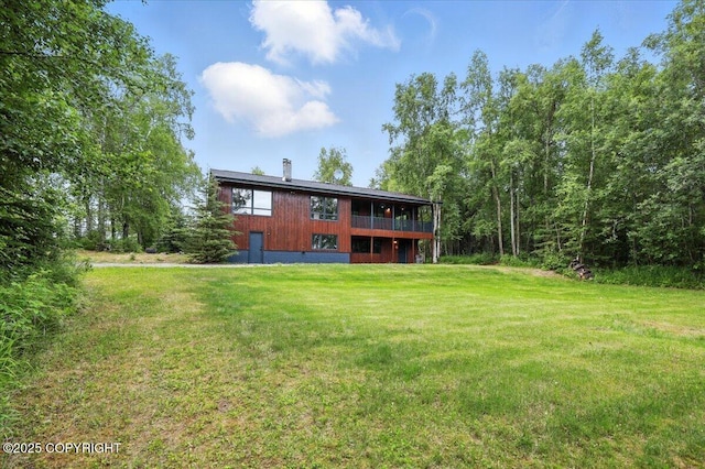 3291 N Edgewater Dr, Wasilla, AK 99623 - rear view of house featuring a lawn, a chimney, and a wooden deck