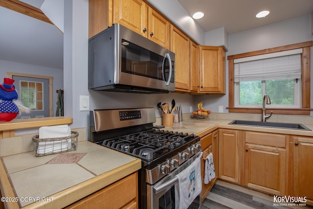 14327 E Birch Cir, Talkeetna, AK 99676 - kitchen featuring appliances with stainless steel finishes, tile counters, wood finished floors, and recessed lighting