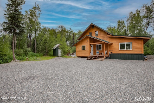 14327 E Birch Cir, Talkeetna, AK 99676 - chalet / cabin with a storage unit, a wooden deck, and gravel driveway