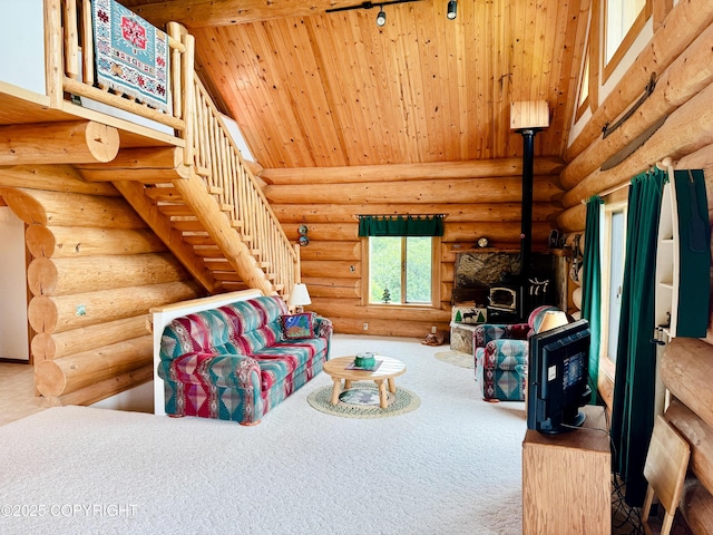 28180 Coastal Vista Cir, Anchor Point, AK 99556 - living room featuring a wood stove, carpet, wood ceiling, log walls, and stairs