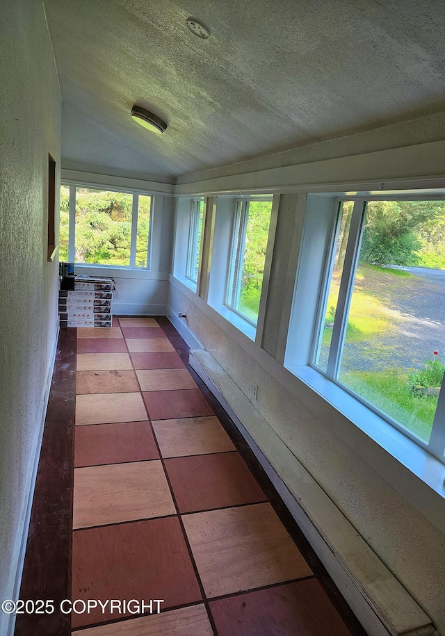 3043 Lakeview Dr, Kodiak, AK 99615 - unfurnished sunroom with a textured wall, a textured ceiling, and lofted ceiling