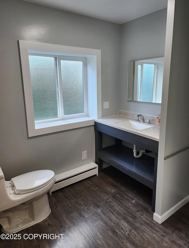3043 Lakeview Dr, Kodiak, AK 99615 - bathroom featuring a baseboard heating unit, healthy amount of natural light, and wood finished floors