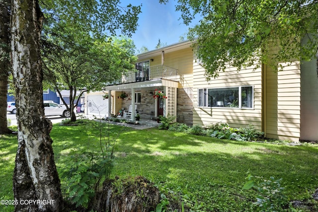 3002 Glacier St, Anchorage, AK 99508 - rear view of property with a balcony, a yard, and stone siding