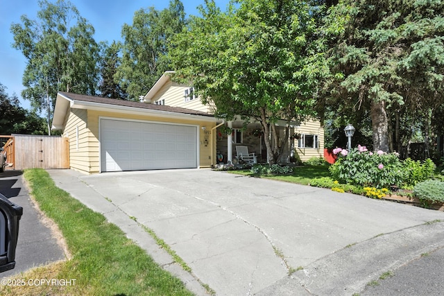 3002 Glacier St, Anchorage, AK 99508 - obstructed view of property featuring an attached garage and a gate