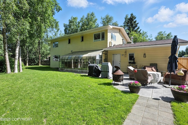 3002 Glacier St, Anchorage, AK 99508 - rear view of house featuring a patio area, a sunroom, and a lawn