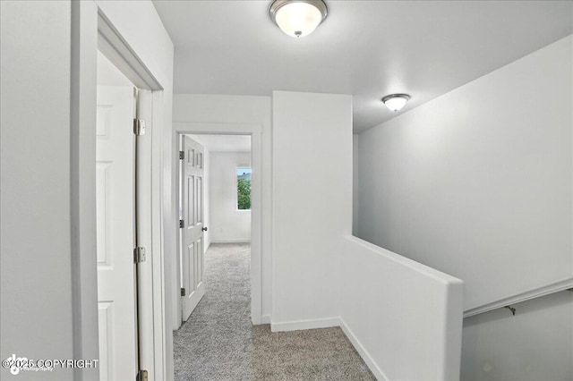 165 Rusty Allen Pl # 64, Anchorage, AK 99504 - hallway featuring carpet and baseboards