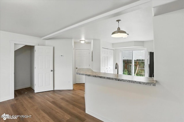 165 Rusty Allen Pl # 64, Anchorage, AK 99504 - kitchen with a peninsula, wood finished floors, pendant lighting, and light countertops