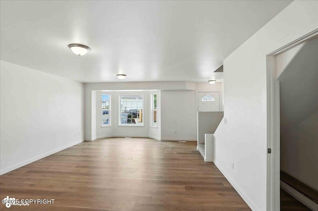 165 Rusty Allen Pl # 64, Anchorage, AK 99504 - unfurnished living room with wood finished floors and baseboards