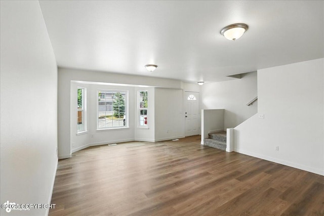 165 Rusty Allen Pl # 64, Anchorage, AK 99504 - unfurnished living room featuring stairs and wood finished floors