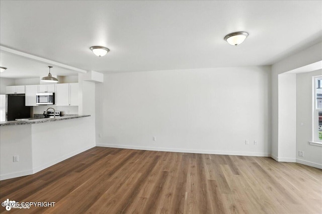 165 Rusty Allen Pl # 64, Anchorage, AK 99504 - unfurnished living room featuring wood finished floors