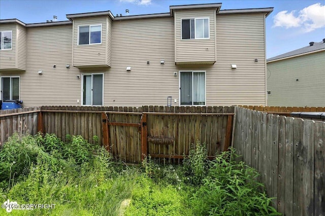 165 Rusty Allen Pl # 64, Anchorage, AK 99504 - rear view of property featuring a fenced backyard