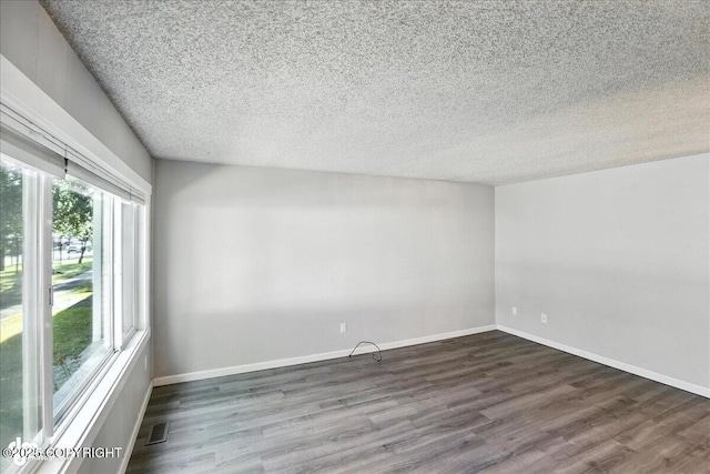 3298 Montpelier Ct Unit 12F, Anchorage, AK 99503 - unfurnished room featuring wood finished floors and a textured ceiling