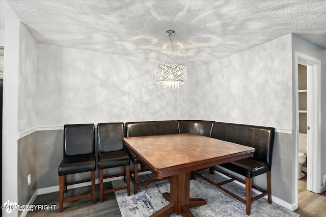 3298 Montpelier Ct Unit 12F, Anchorage, AK 99503 - dining space featuring wood finished floors, a textured ceiling, and breakfast area