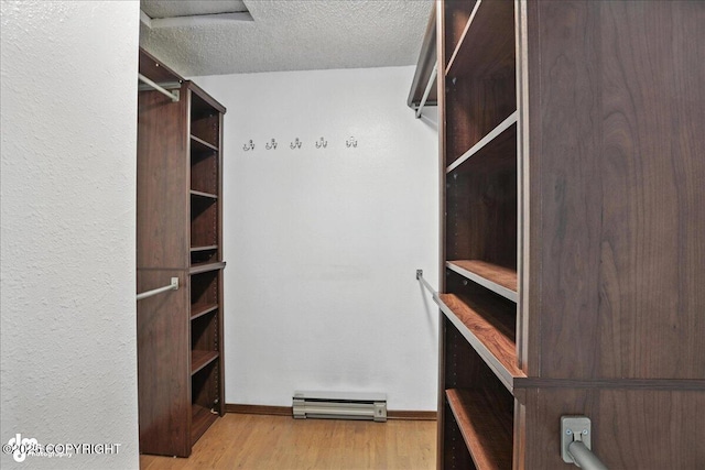 3298 Montpelier Ct Unit 12F, Anchorage, AK 99503 - walk in closet featuring wood finished floors and baseboard heating