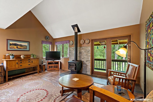 7409 S Timberview Dr, Wasilla, AK 99623 - living room featuring a wood stove, high vaulted ceiling, and wood finished floors
