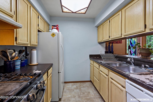 7409 S Timberview Dr, Wasilla, AK 99623 - kitchen with dishwasher, under cabinet range hood, dark countertops, a skylight, and gas range