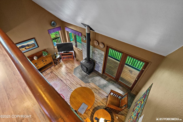 7409 S Timberview Dr, Wasilla, AK 99623 - living room featuring a wood stove, vaulted ceiling, and wood finished floors
