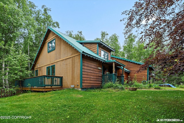 7409 S Timberview Dr, Wasilla, AK 99623 - back of house featuring a lawn, a metal roof, and a wooden deck