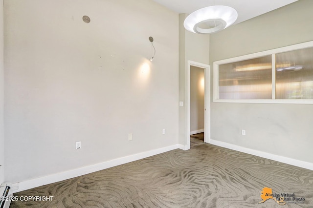 124 E 7th Ave, Anchorage, AK 99501 - empty room with carpet floors and a baseboard heating unit