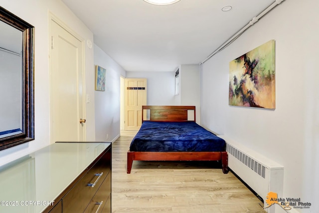 124 E 7th Ave, Anchorage, AK 99501 - bedroom featuring radiator and light wood finished floors