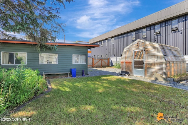 124 E 7th Ave, Anchorage, AK 99501 - back of house featuring an outdoor structure and a greenhouse