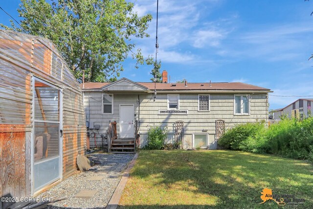 124 E 7th Ave, Anchorage, AK 99501 - back of house featuring a lawn