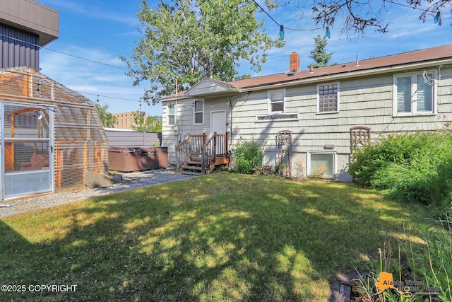 124 E 7th Ave, Anchorage, AK 99501 - back of house with a hot tub, a chimney, and a yard