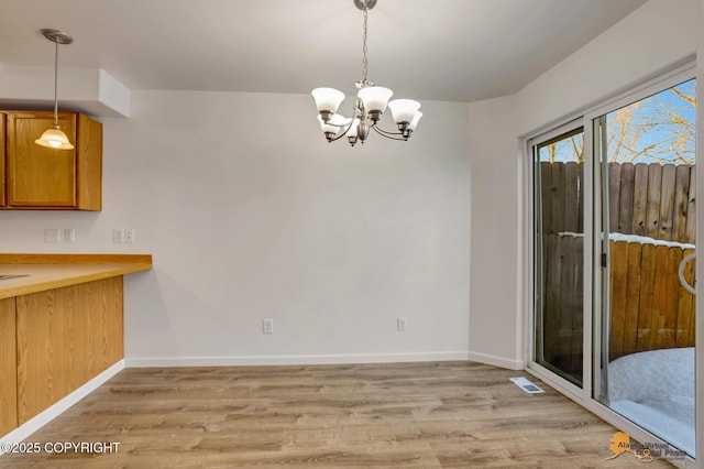 6314 Whispering Loop # 30A, Anchorage, AK 99504 - unfurnished dining area with light wood-style floors and a chandelier