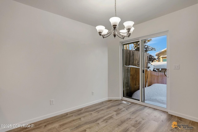 6314 Whispering Loop # 30A, Anchorage, AK 99504 - unfurnished room with a chandelier and light wood finished floors