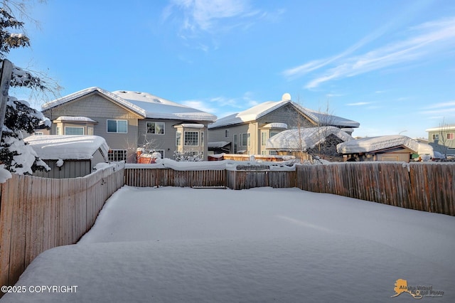 6314 Whispering Loop # 30A, Anchorage, AK 99504 - yard layered in snow featuring a fenced backyard