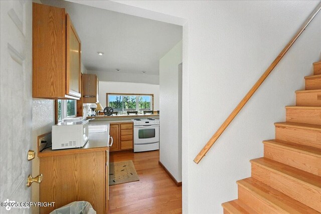 34494 Grizzly Ln, Sterling, AK 99672 - kitchen with white appliances, light wood-style floors, and light countertops