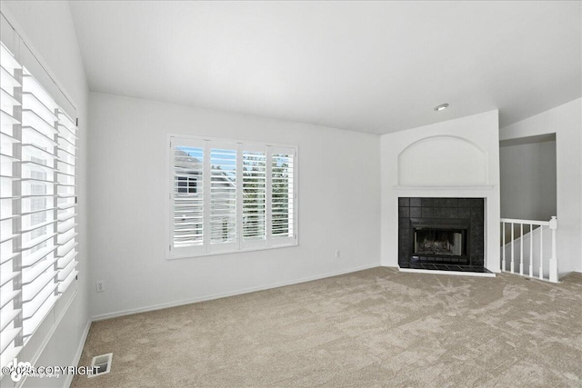 3709 Encore Cir, Anchorage, AK 99507 - unfurnished living room with carpet and a tiled fireplace