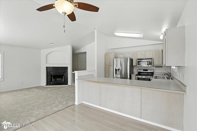 3709 Encore Cir, Anchorage, AK 99507 - kitchen with appliances with stainless steel finishes, lofted ceiling, ceiling fan, light wood finished floors, and light countertops