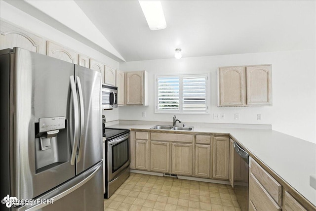 3709 Encore Cir, Anchorage, AK 99507 - kitchen with appliances with stainless steel finishes, light brown cabinetry, vaulted ceiling, and light countertops