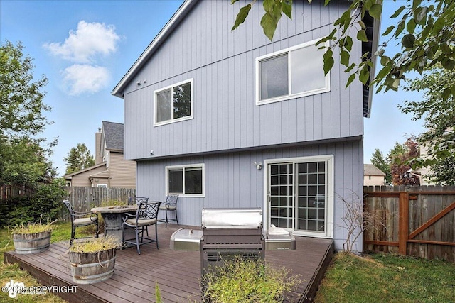 3709 Encore Cir, Anchorage, AK 99507 - back of house with a fenced backyard, a deck, and a fire pit