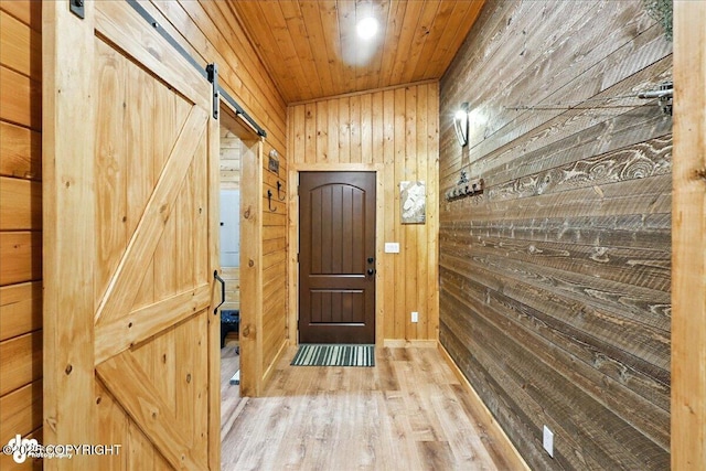 23634 Kasilof River Cir, Kasilof, AK 99610 - doorway featuring wooden walls, a barn door, wood finished floors, and wood ceiling