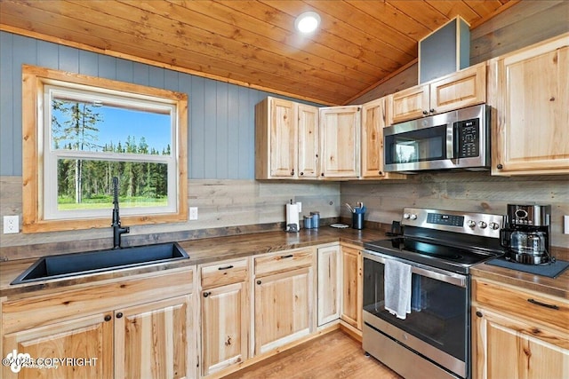 23634 Kasilof River Cir, Kasilof, AK 99610 - kitchen featuring stainless steel appliances, light brown cabinetry, vaulted ceiling, wood ceiling, and dark countertops