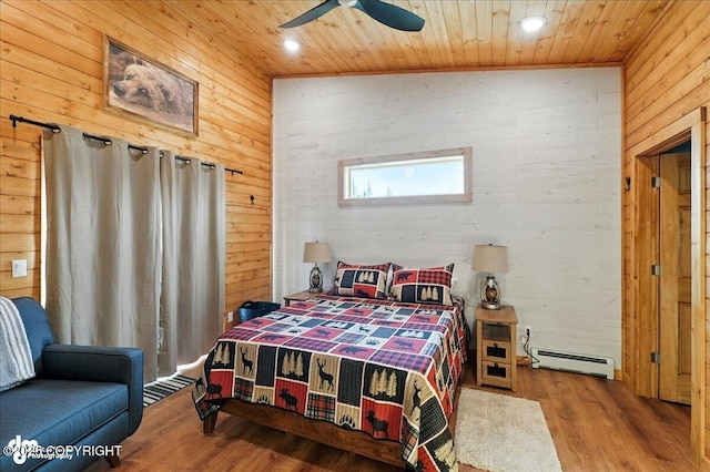 23634 Kasilof River Cir, Kasilof, AK 99610 - bedroom featuring a baseboard heating unit, wooden ceiling, wood walls, wood finished floors, and ceiling fan