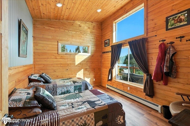 23634 Kasilof River Cir, Kasilof, AK 99610 - bedroom with a baseboard radiator, wood walls, recessed lighting, wood finished floors, and wood ceiling